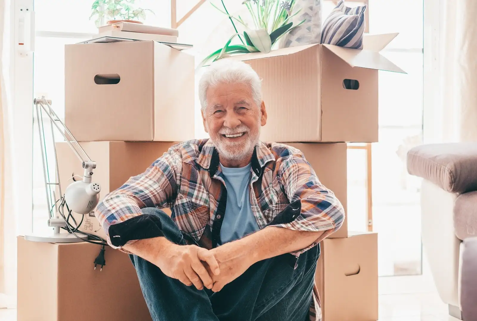 A man poses in front of moving boxes