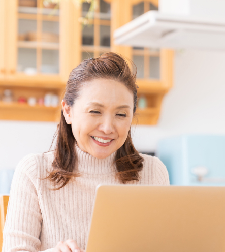 a woman smiling while using her computer