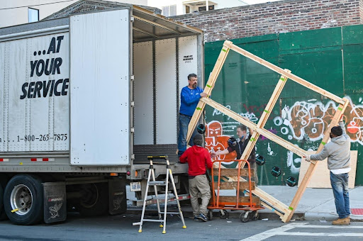 three men unloading a truck