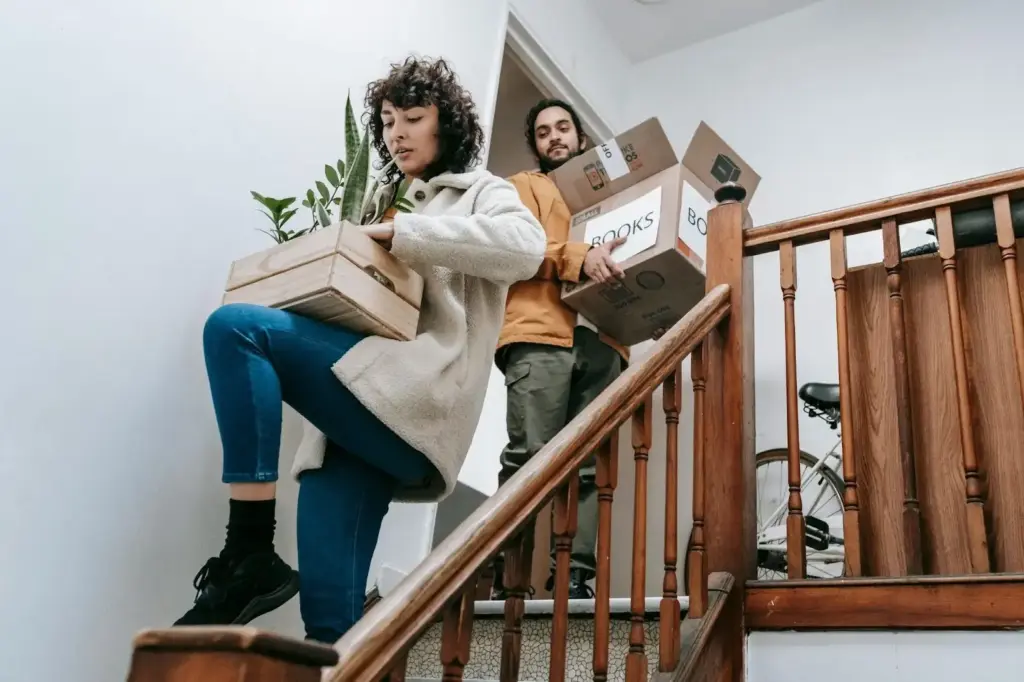 Woman and man loading up boxes and plants