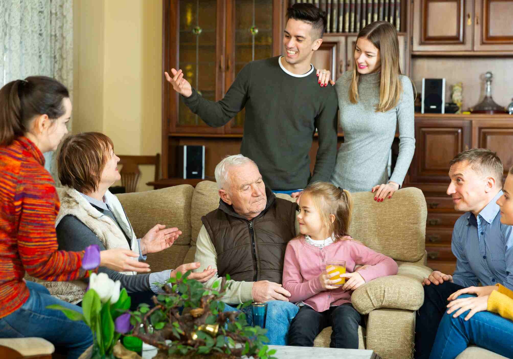 Big family with grandparents and children spending time together at home