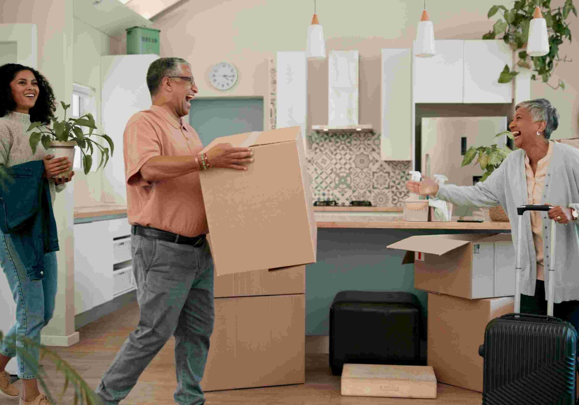 Senior parents, woman and boxes in new home for help, support or luggage with family at property. People, mother and dad with moving, suitcase or excited for investment in real estate for retirement