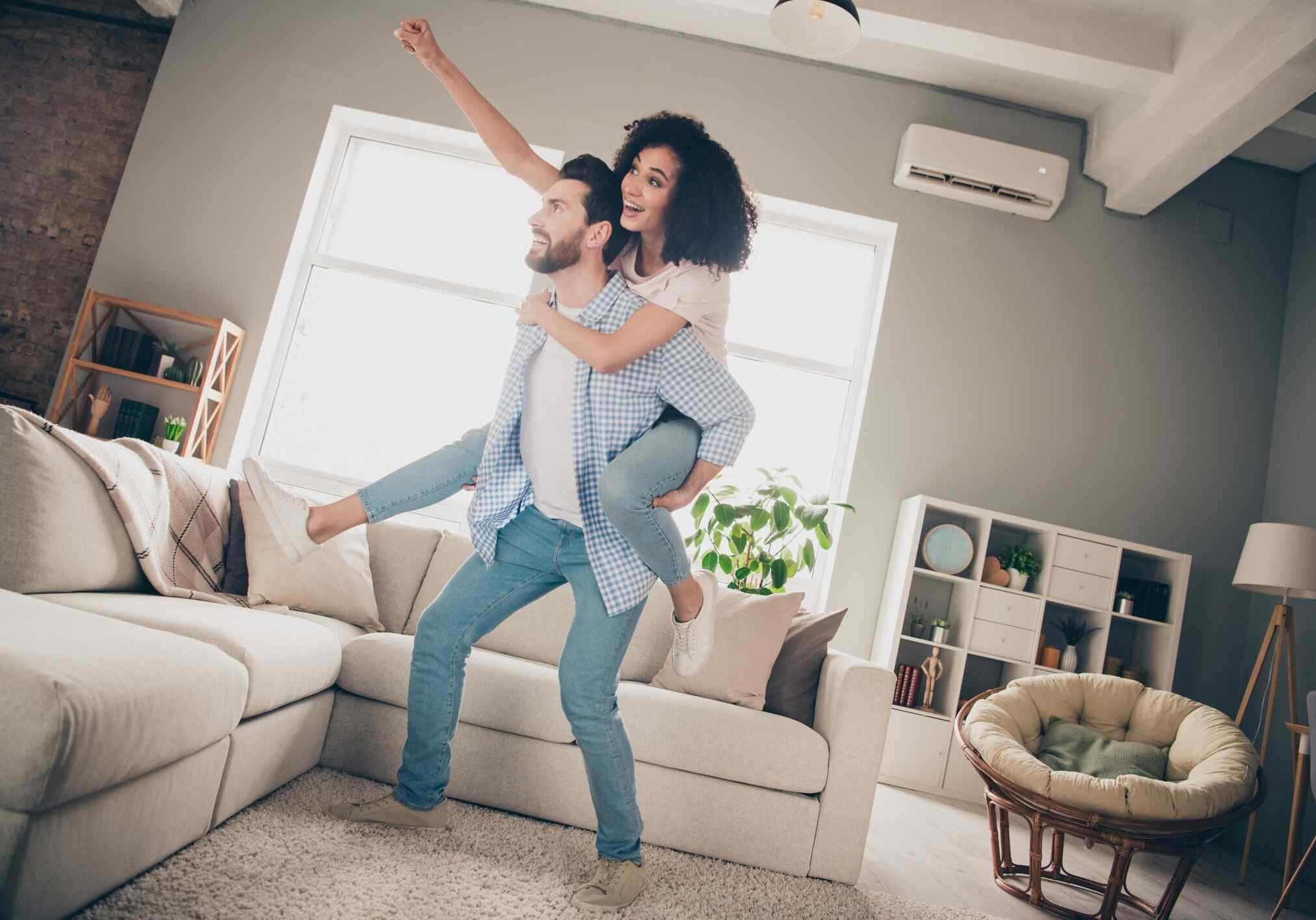 Full size photo of two young idyllic partners piggyback good mood modern interior living room apartment indoors.