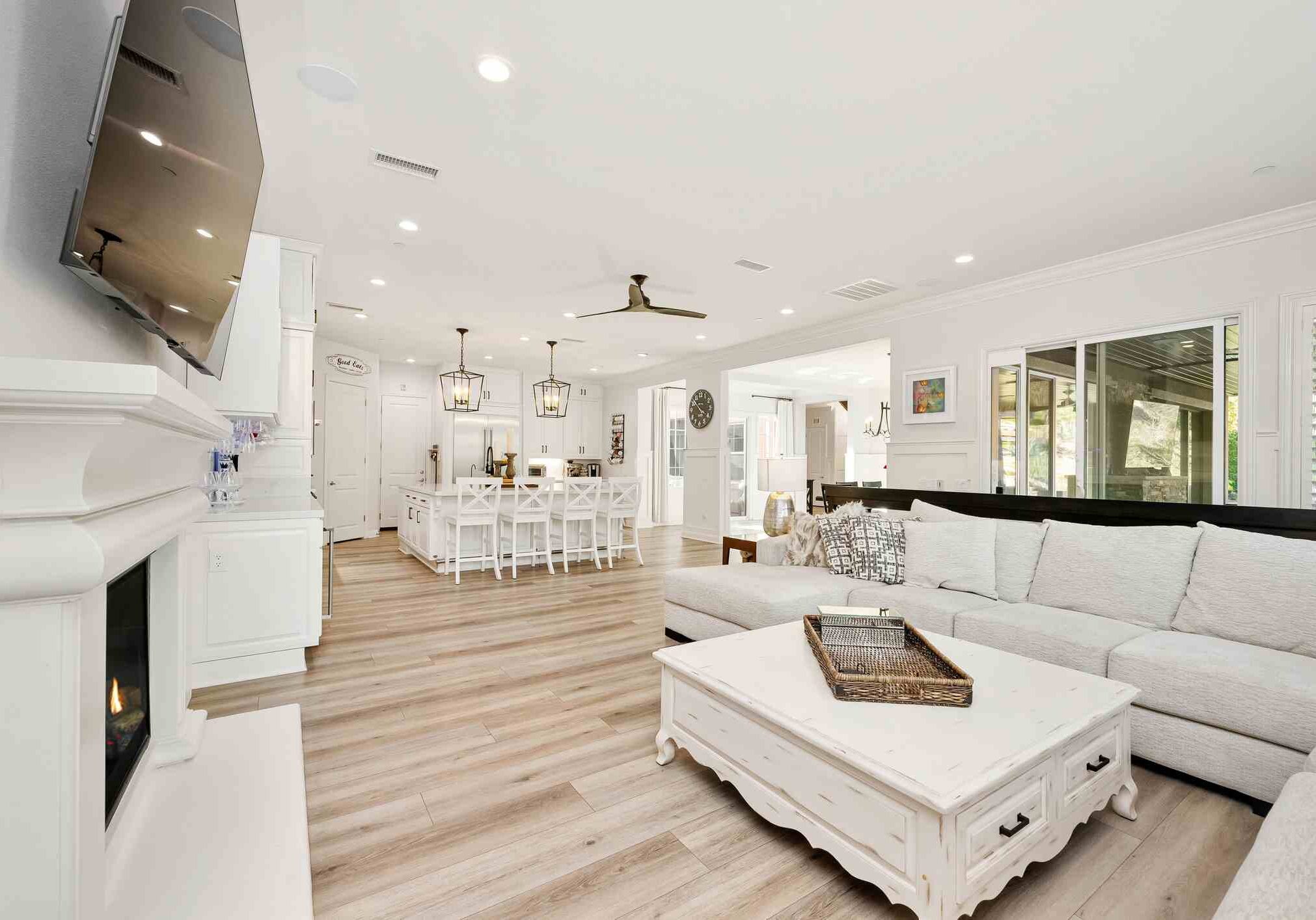A bright and elegant open-concept living space with a cozy sofa, and stylish furnishings in a luxury home