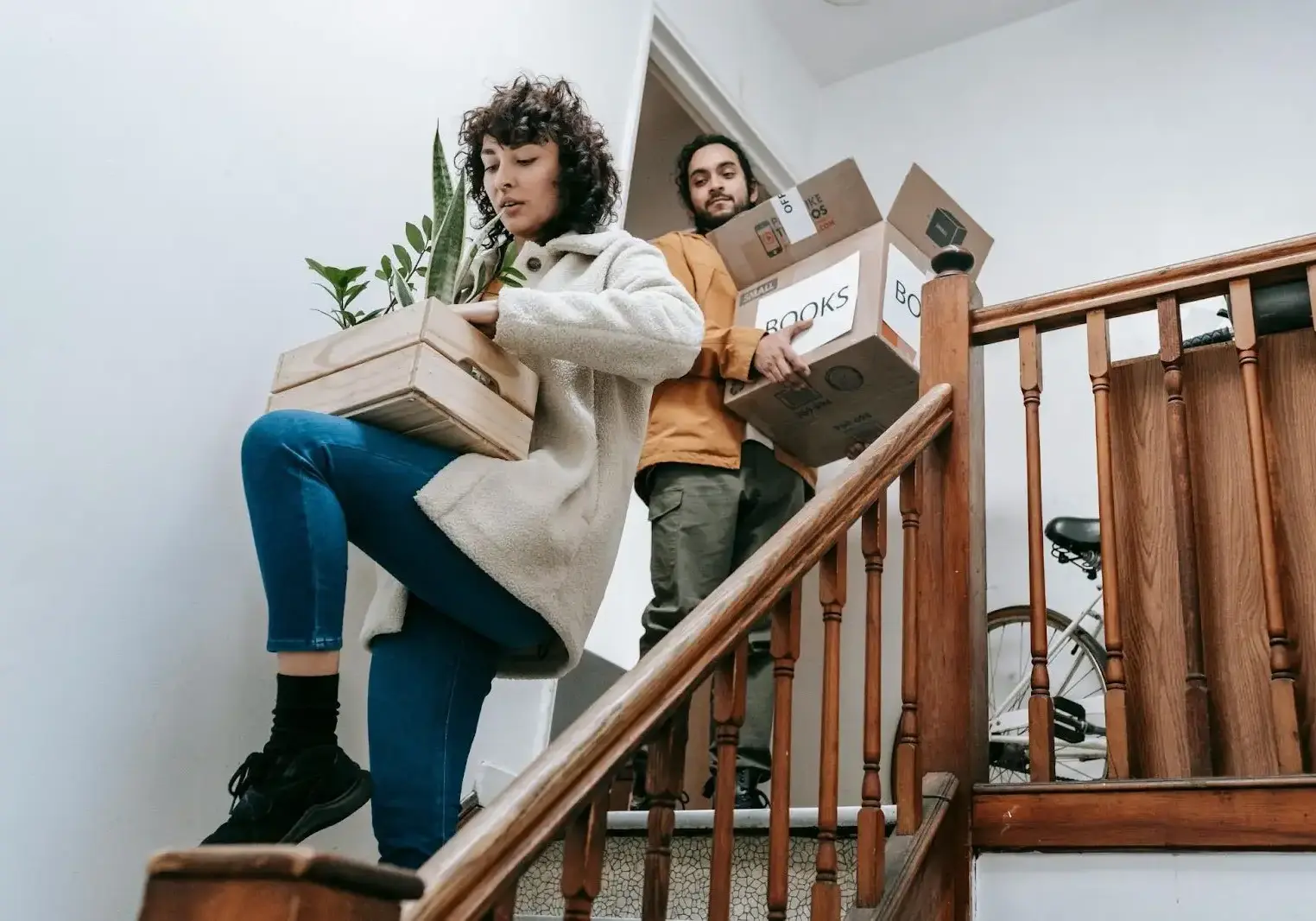 Woman and man loading up boxes and plants
