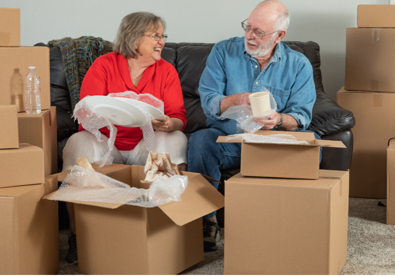 elderly couple packing boxes